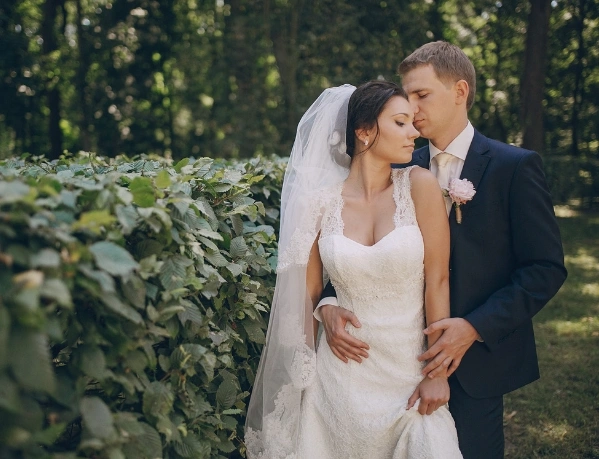 Bride and groom embracing during outdoor wedding photoshoot
